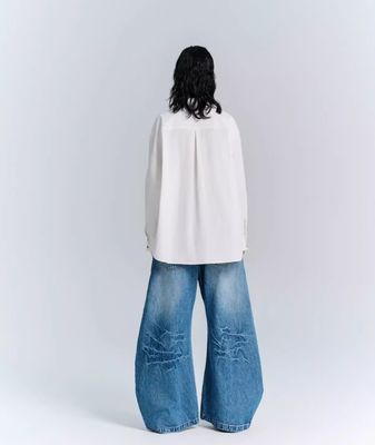 Jeans de pantalones de denim de tejido deconstruido para hombres y mujeres en ropa callejera de talla grande
