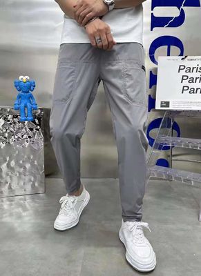 Pantalones de carga masculinos de estilo frontal plano en stock con botones personalizados Corredores de fitness sueltos
