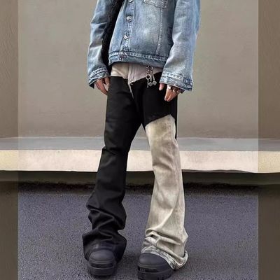 Mediana cintura Tejido de denim a medida Lavado con bordes crudos Parcheado Pantalones desbordados Jeans para hombres