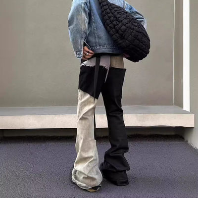 Mediana cintura Tejido de denim a medida Lavado con bordes crudos Parcheado Pantalones desbordados Jeans para hombres